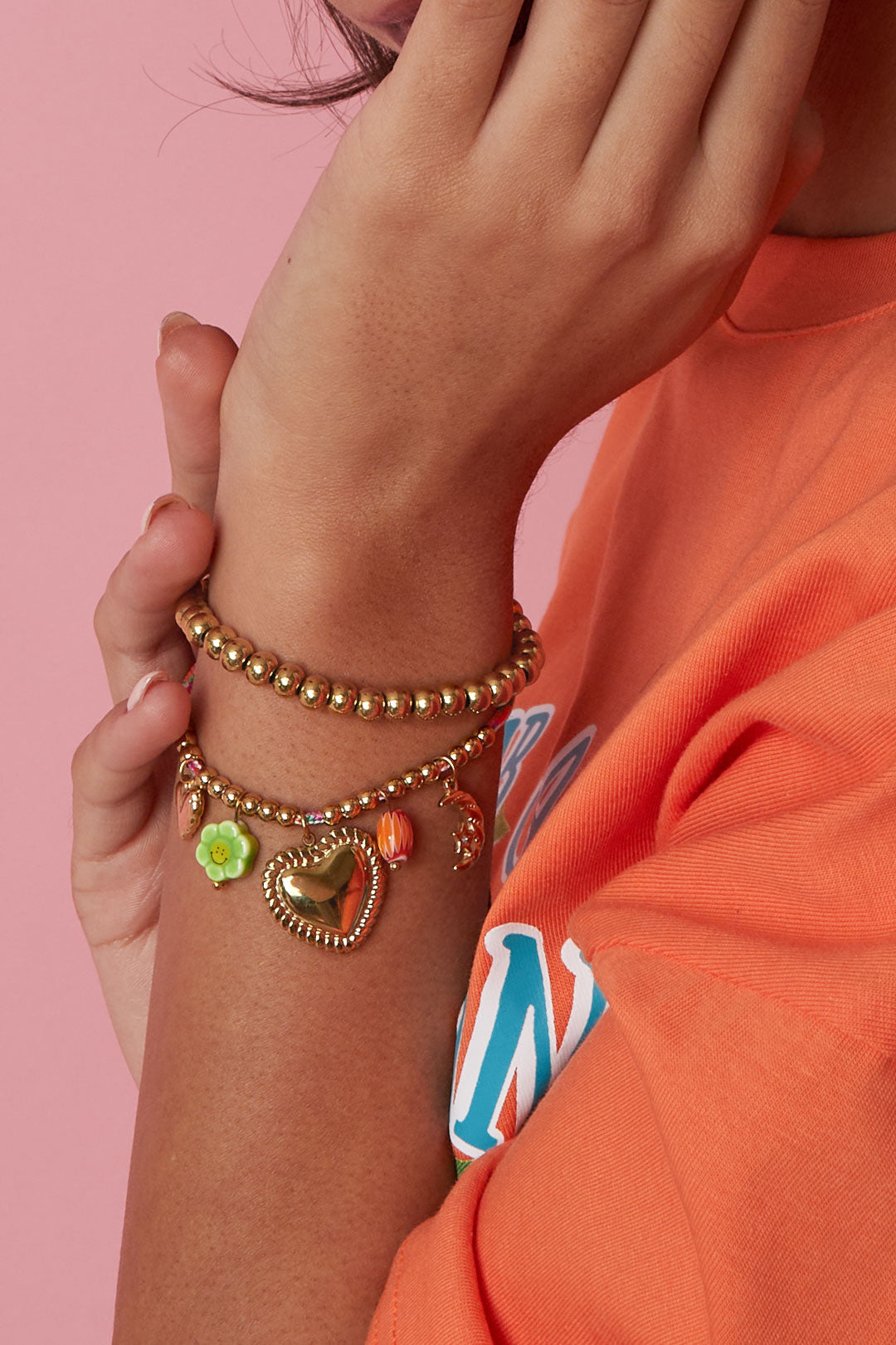 Colorful cord bracelet with various pendants and beads